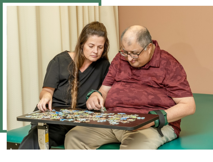 elderly man doing a puzzle